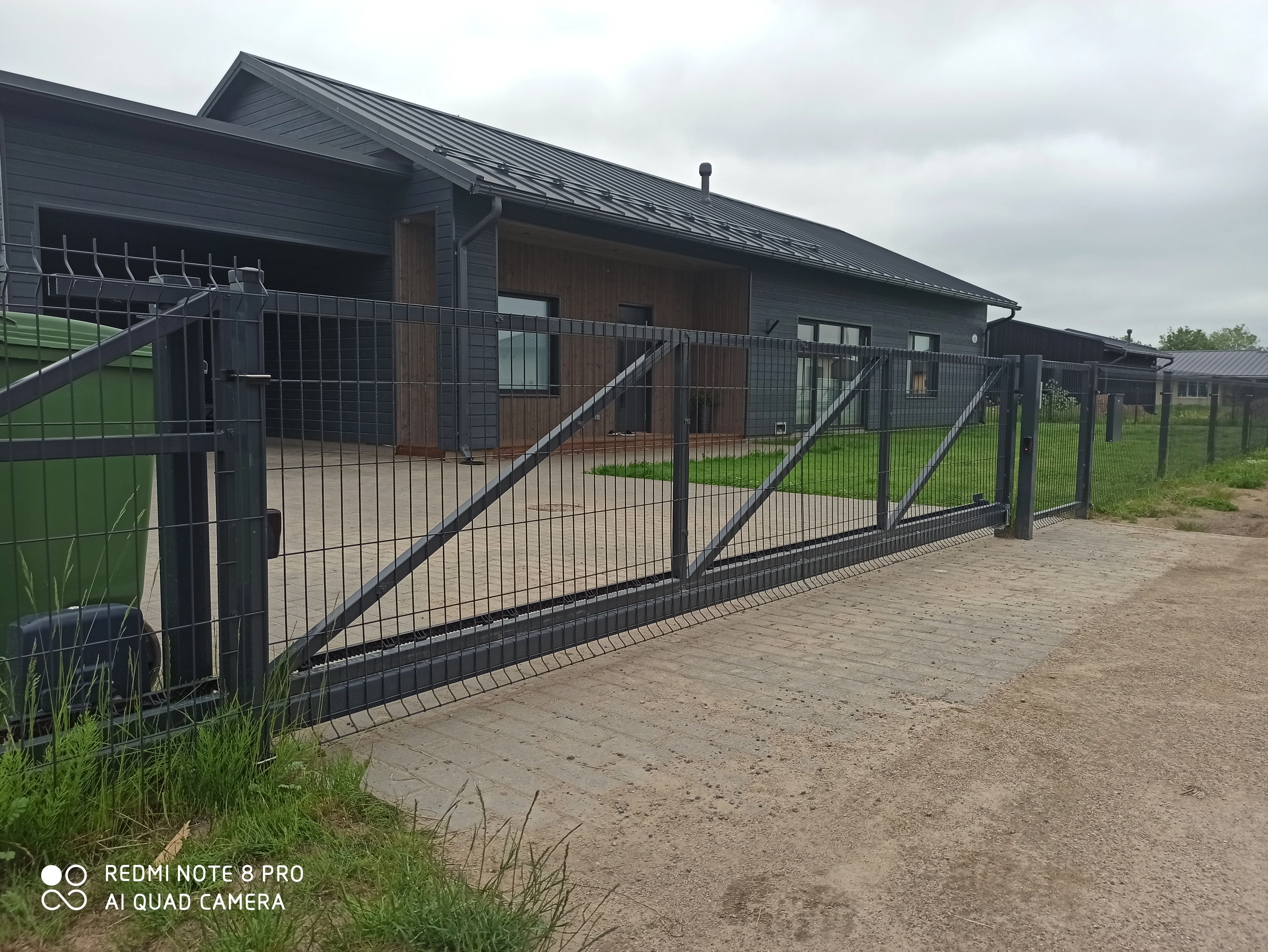 Varav - antratsiithall keevispaneel liugvärav automaatikaga modernse maja ees